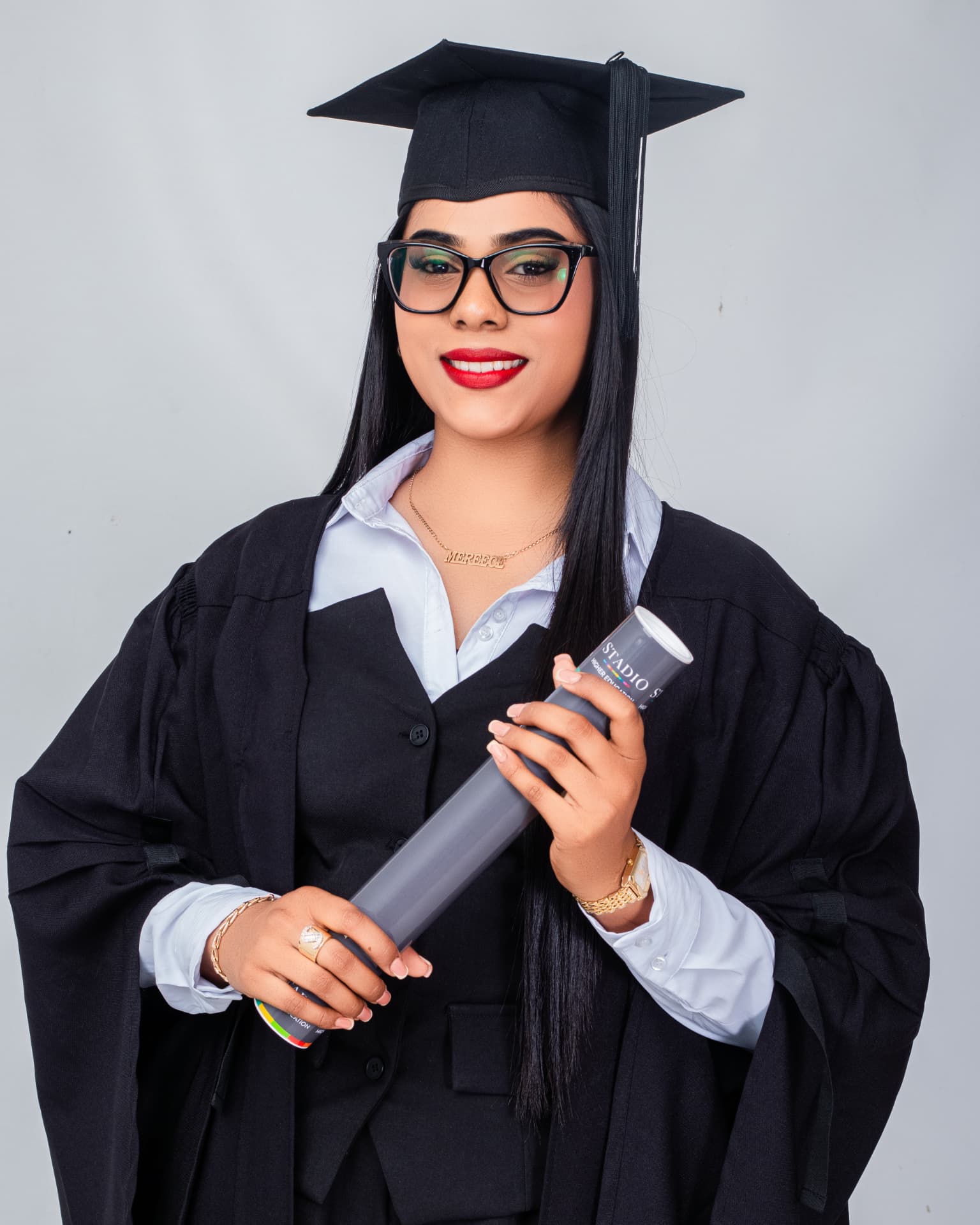 Graduate in cap and gown holding a scroll