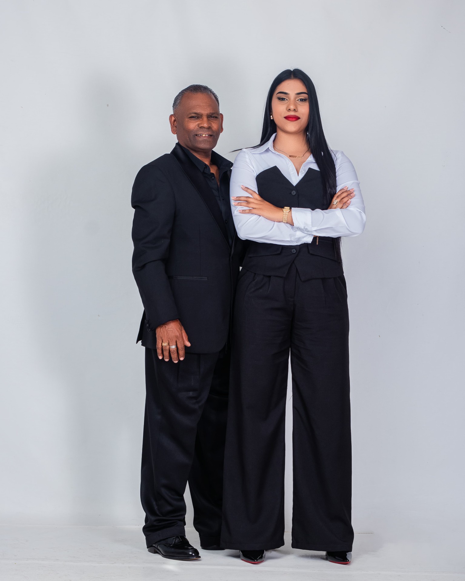 Studio portrait of a father and daughter in formal black