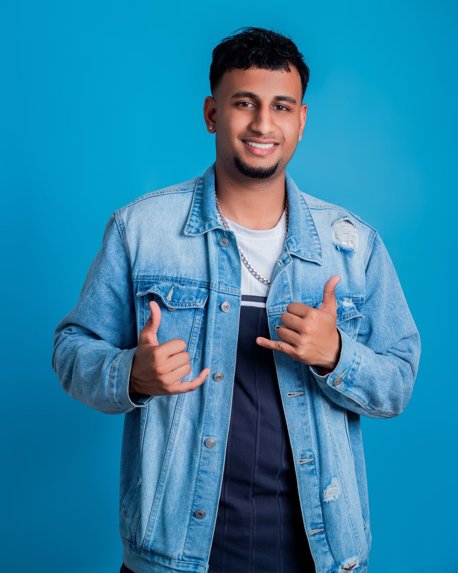 Close studio portrait of a man in a denim jacket