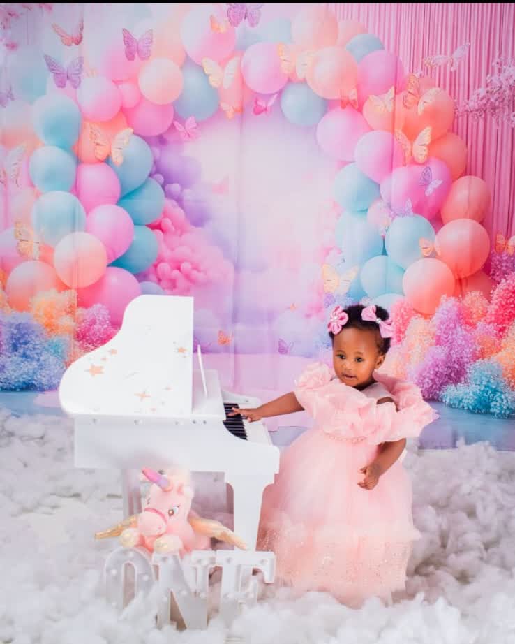Baby girl in a pink gown at a first birthday ONE set