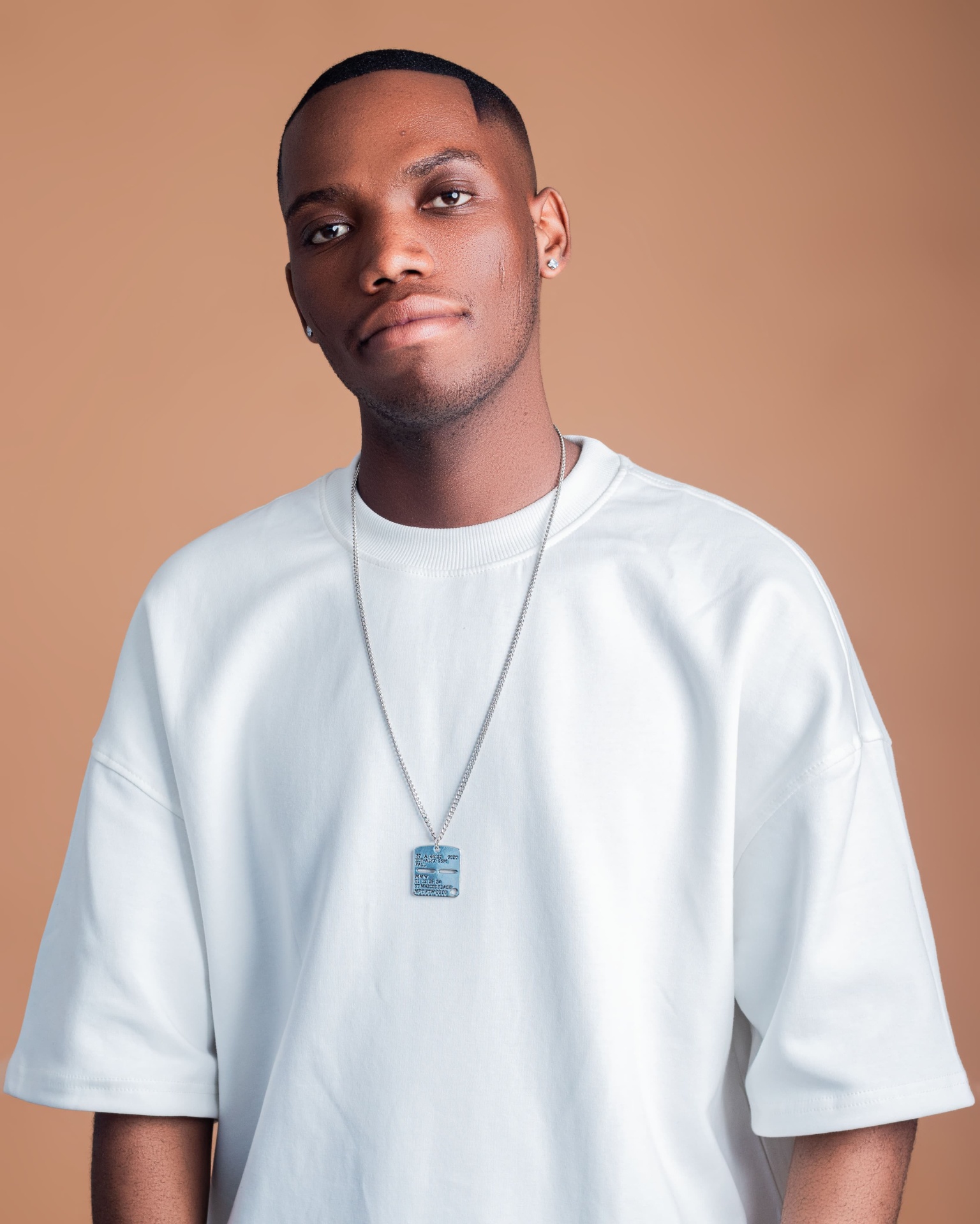 Close studio portrait of a man in a white T-shirt