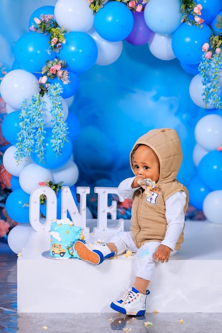 Baby boy tasting his first birthday cake at the ONE set