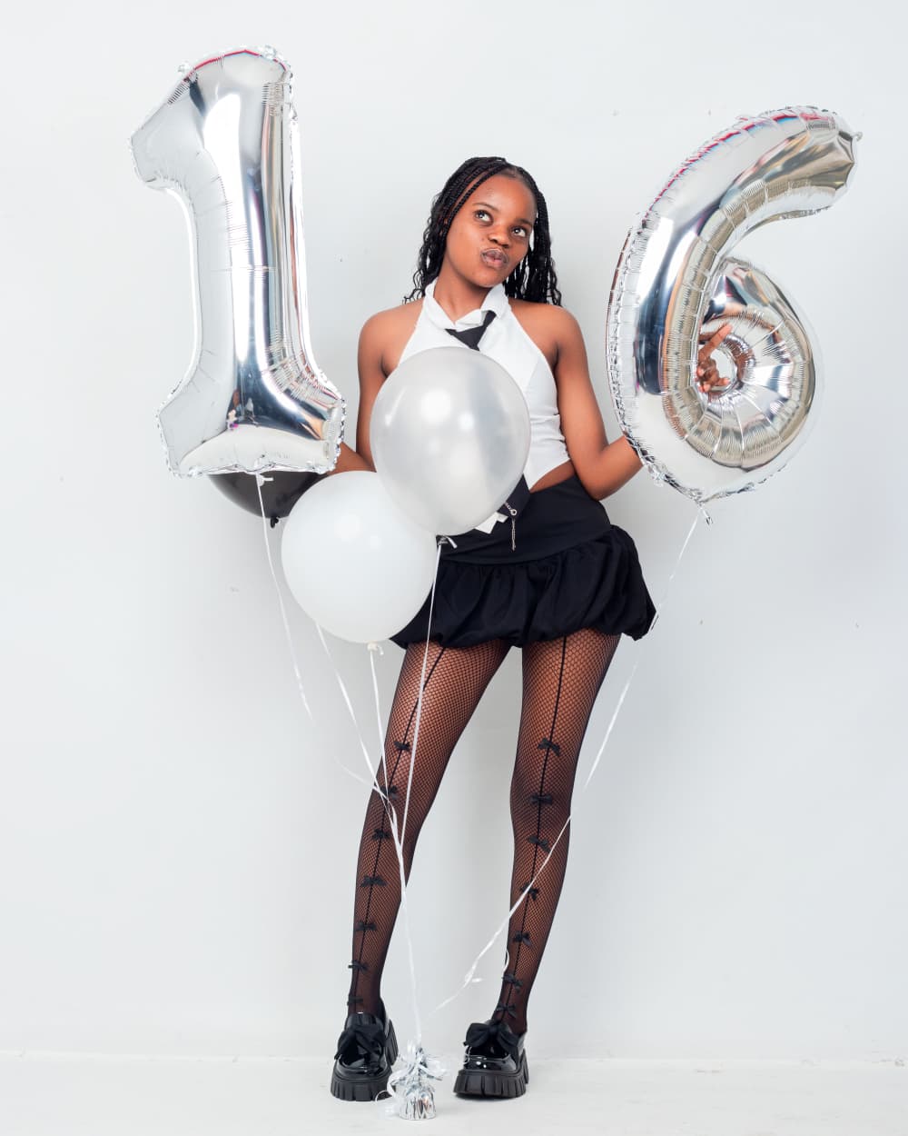 Teen girl with silver 16 balloons