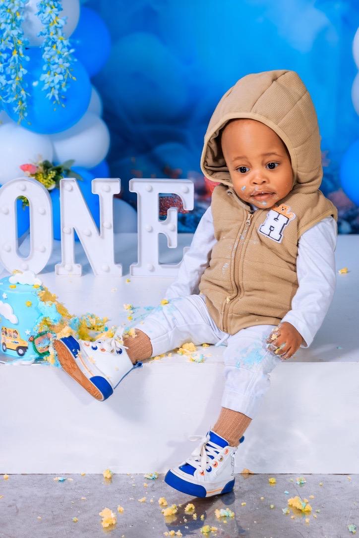 Cake smash portrait of a one-year-old boy at the ONE letters
