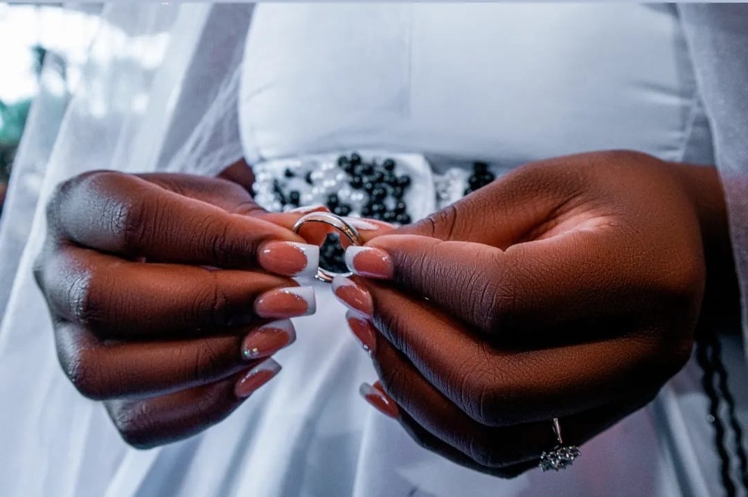 Bride holding wedding rings in her hands